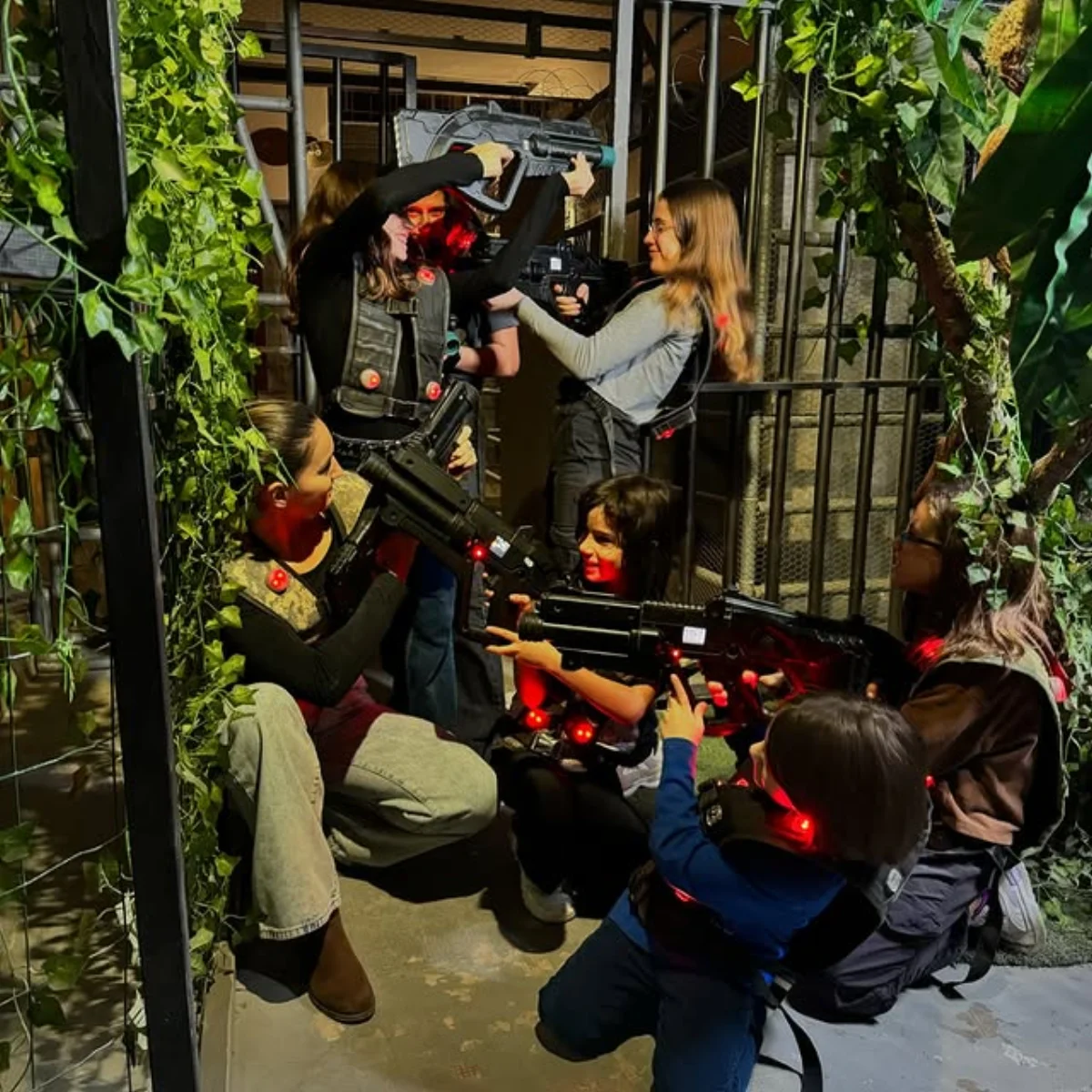 Group of kids playing laser tag in the jungle-themed arena